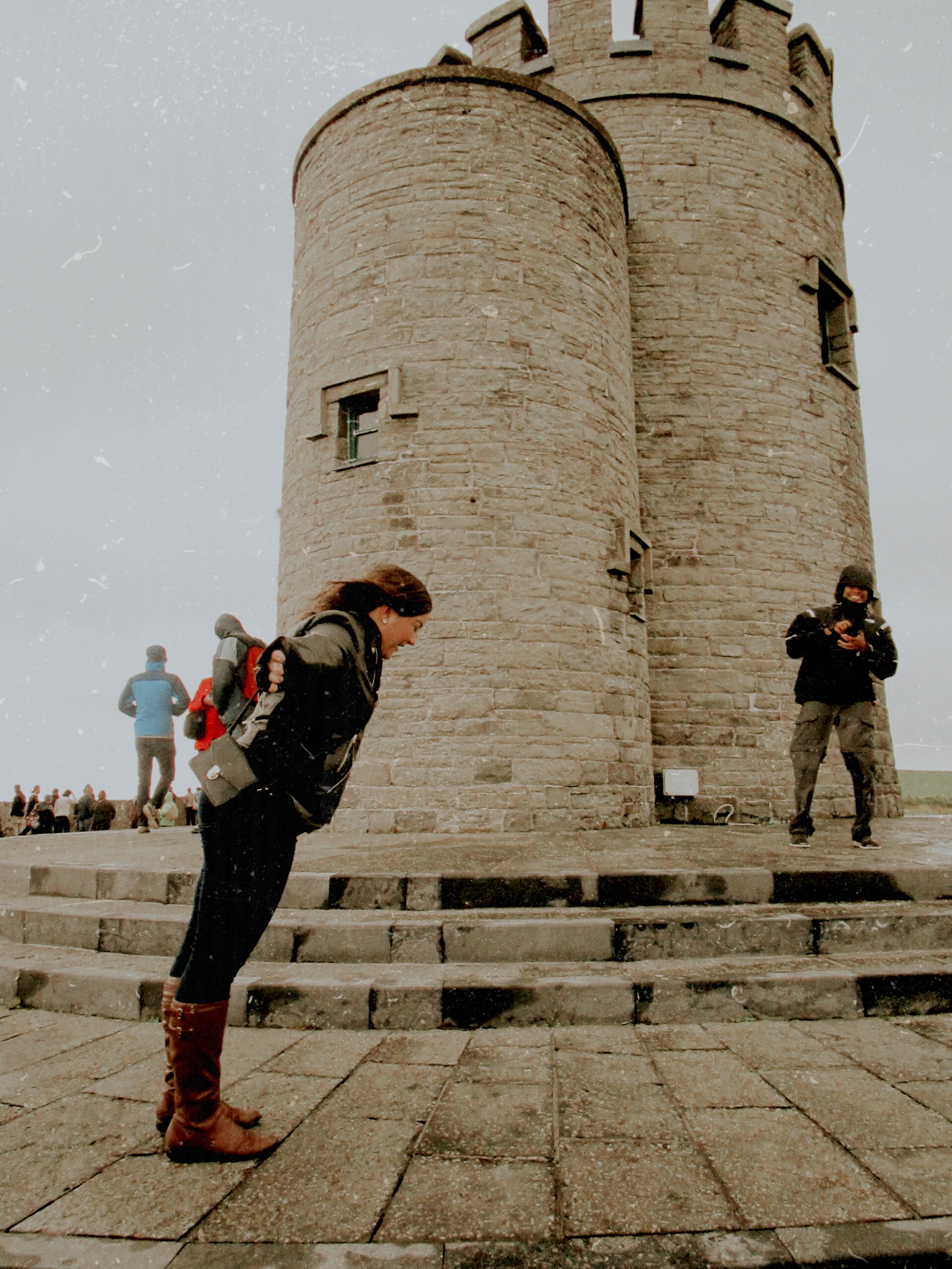 Girl getting blown by wind at the Cliffs of Moher