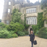 A picture of a woman in front of Malahide Castle in Ireland