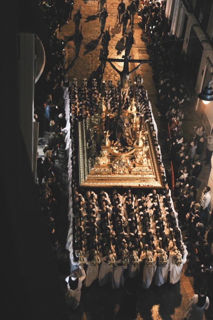 men holding a throne in a Semana Santa procession