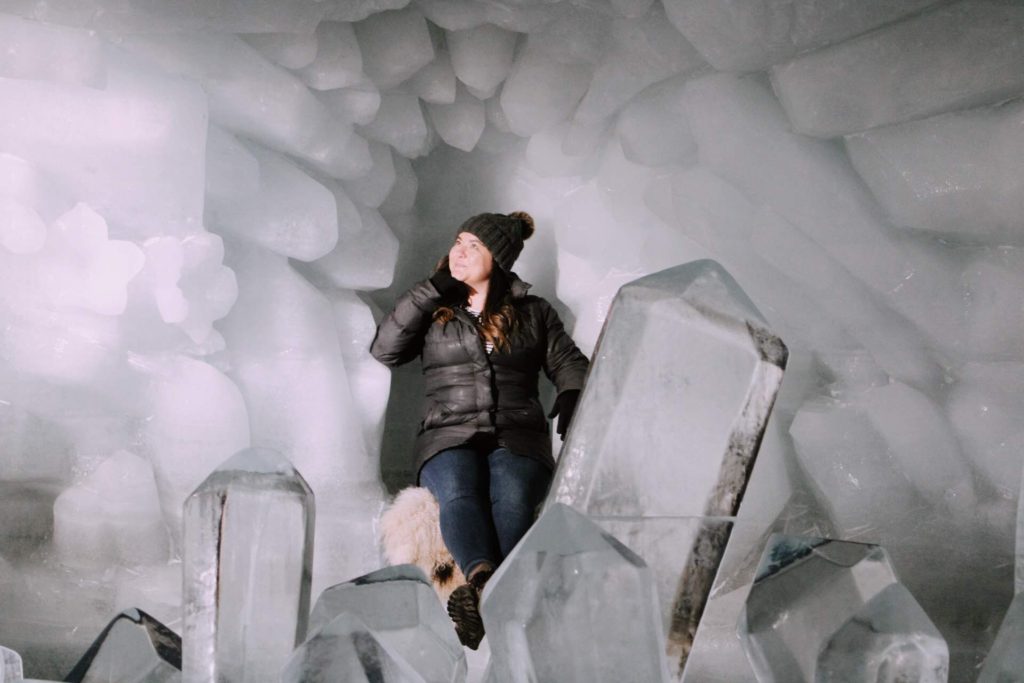 Posing near an ice sculpture in the glacier cave at Matterhorn Glacier Paradise near Zermatt, Switzerland