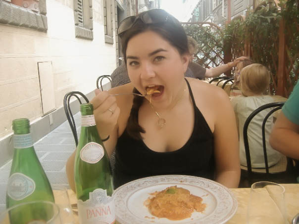 Girl eating pasta in Rome