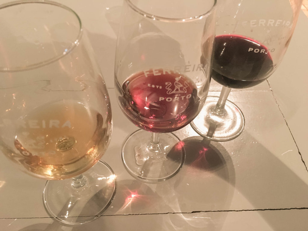 Three types of Port wine in glasses on a table from Ferreira Cellar in Porto, Portugal. 